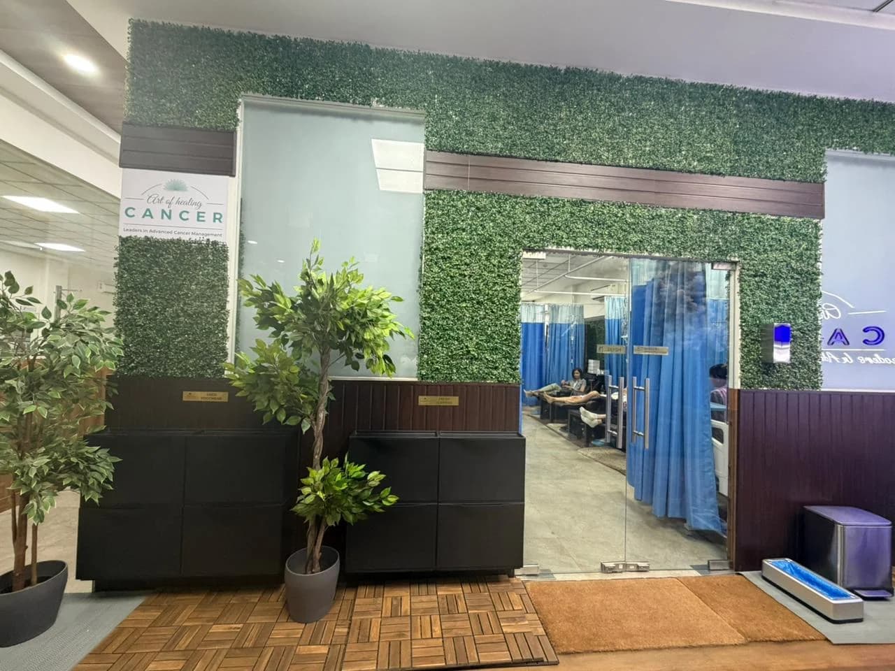 Calm, green-walled patient recovery area with private infusion cubicles