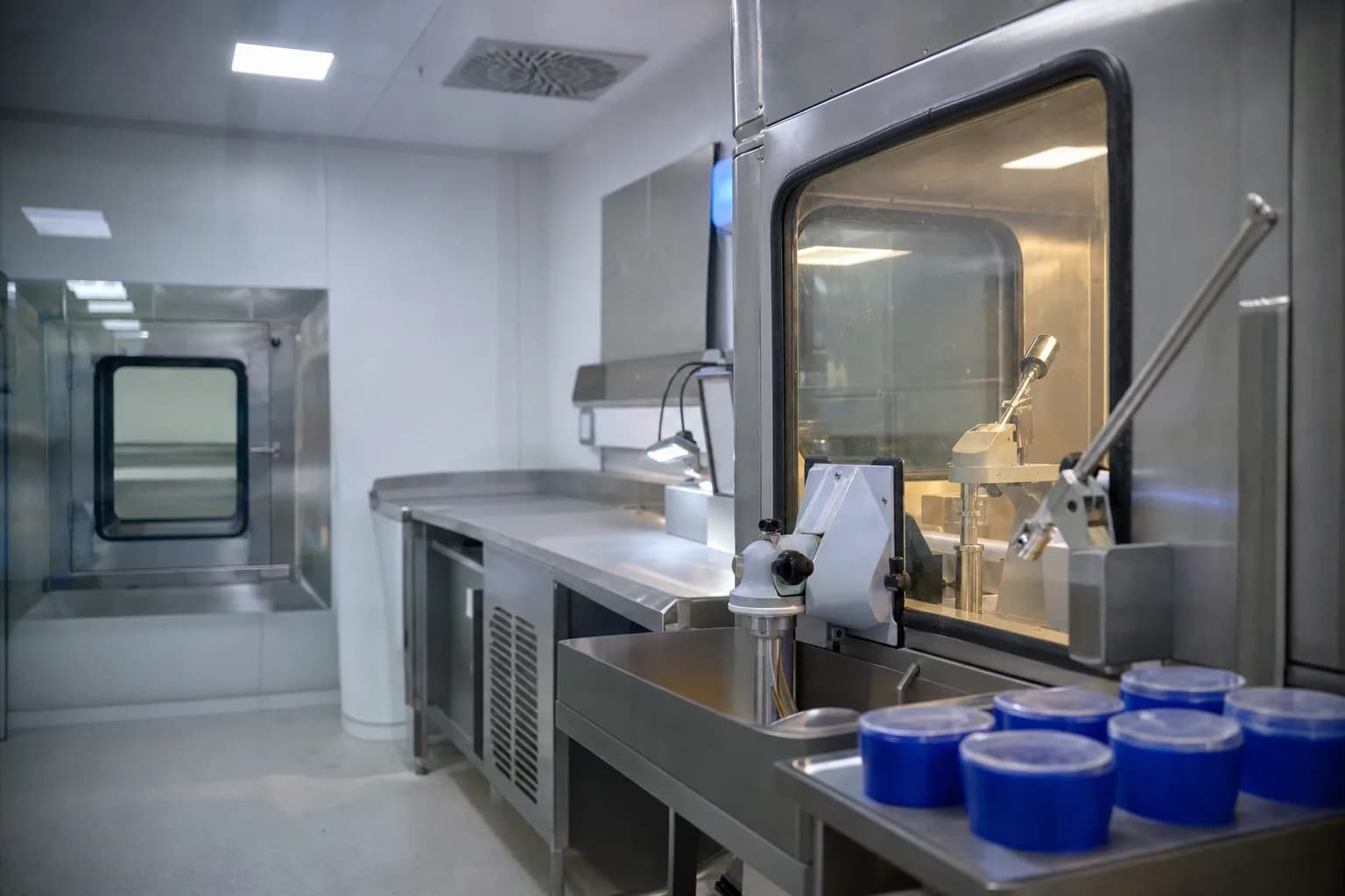 Interior of our radiopharmacy hot lab - stainless steel surfaces, lead-glass shielded workstation, sample containers prepared on-site